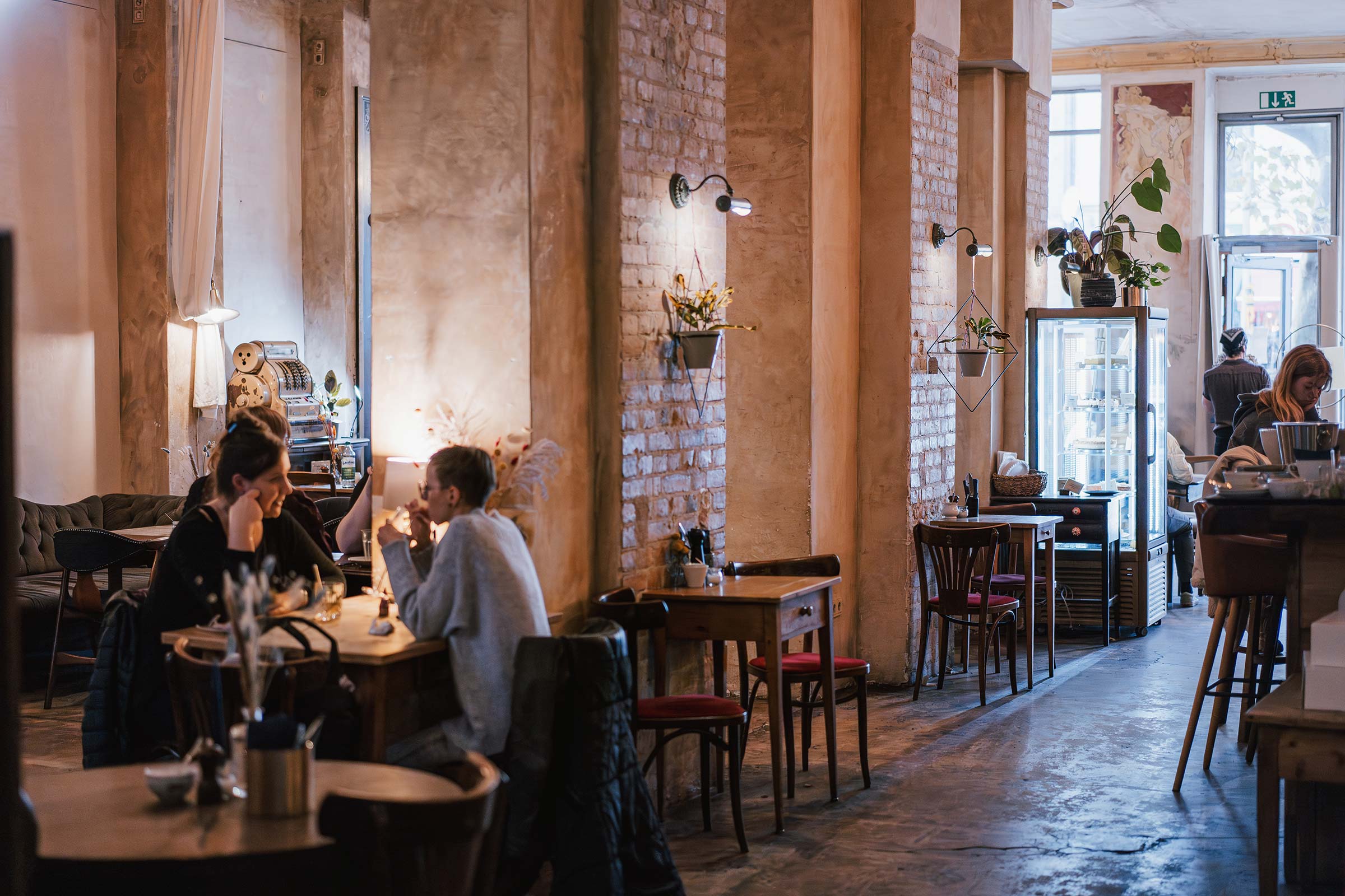 Blick in das Kaffeehaus Zimt & Zucker, mit schönen Vitage Möbeln und Blumendekoration.